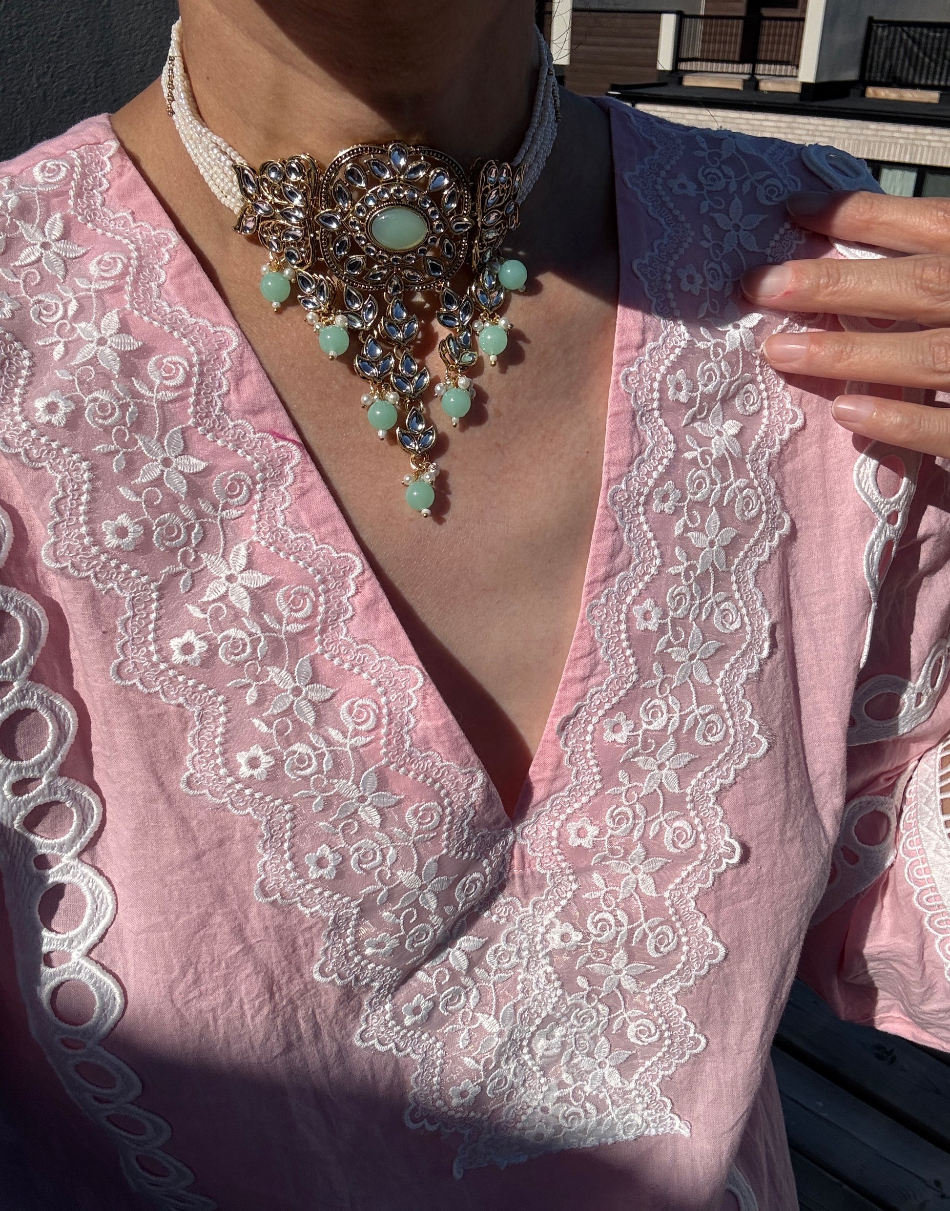 Person wearing a mint choker 